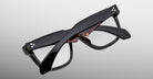 Jacques Marie Mage Hyannis in Noir q5 eyeglasses, black frames with tortoiseshell accents, folded, top-down back view.