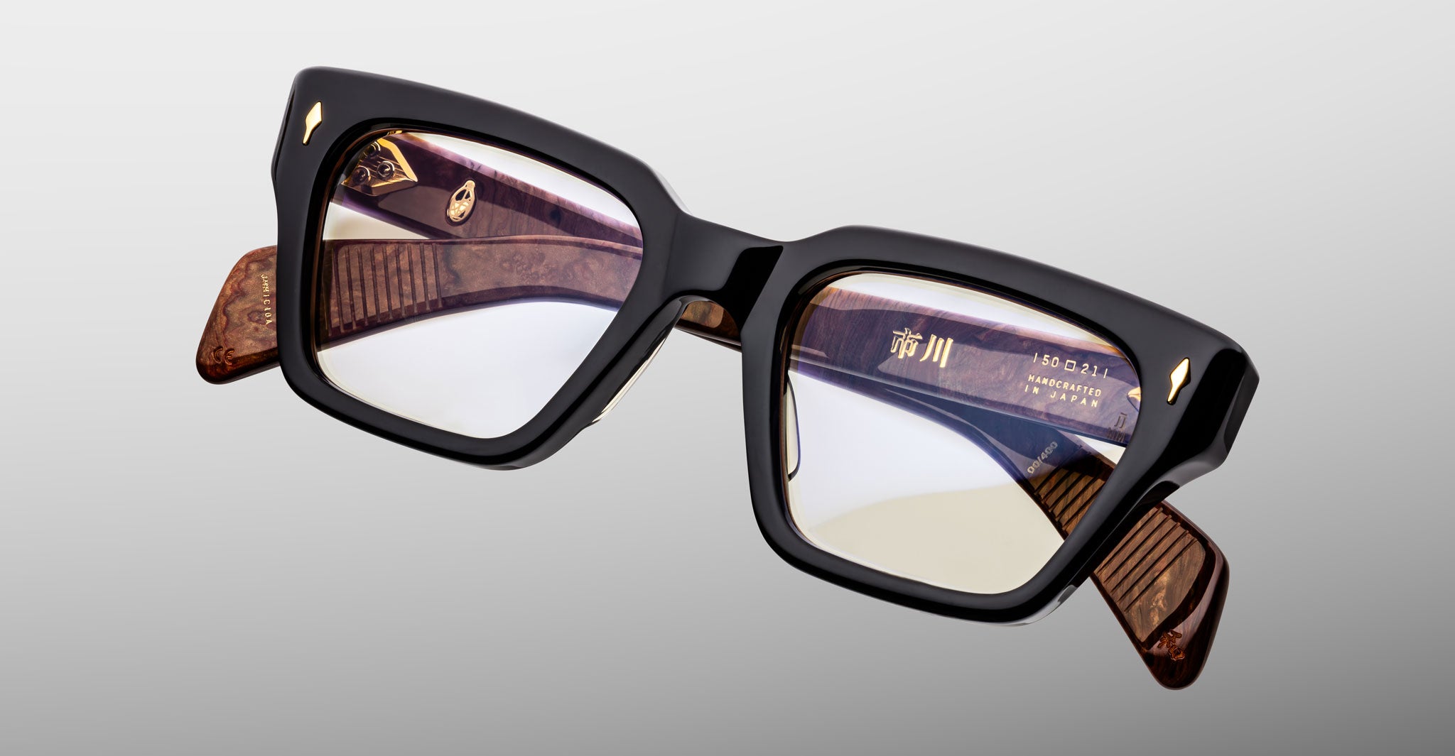 Jacques Marie Mage Ichikawa eyeglasses, square black front, brown marbled arms with gold temple writing, side view.