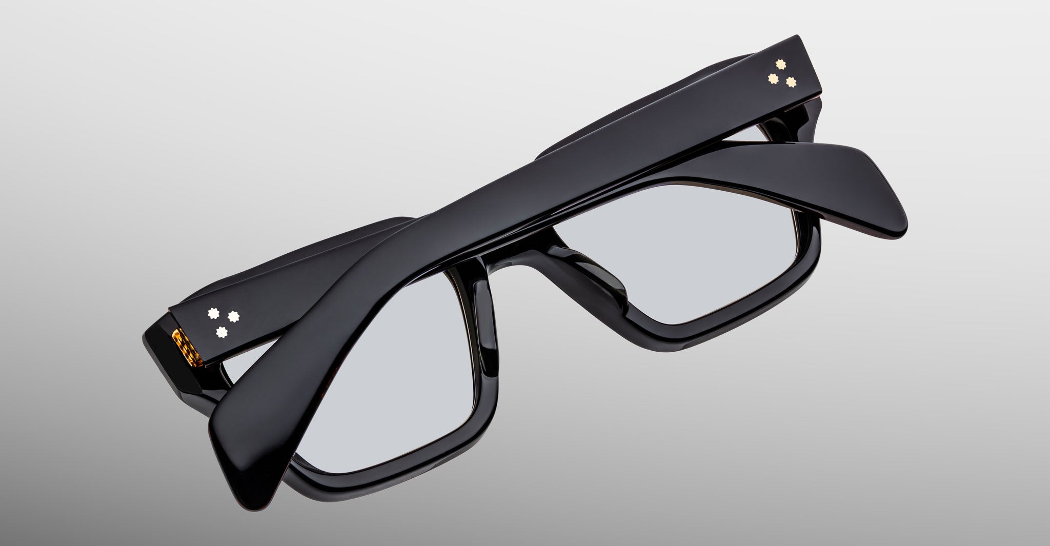 Jacques Marie Mage Ichikawa black rectangular eyeglasses with arms folded, side view.