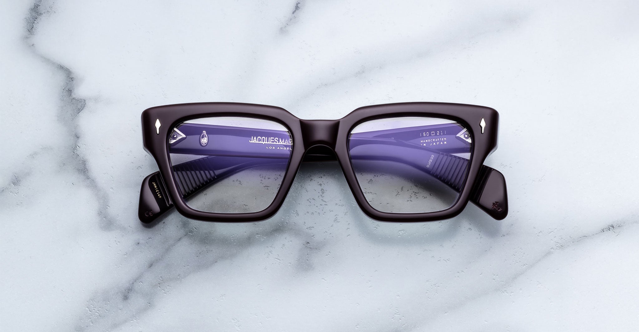 Jacques Marie Mage Ichikawa black square eyeglasses with purple lenses, top view.