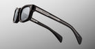 Jacques Marie Mage Initials in Black Mirror black rectangular sunglasses with thick frames and metallic accents, side view.