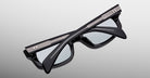 Jacques Marie Mage Initials in Black Mirror black sunglasses with silver accents, product folded, back view.