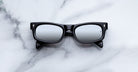 Jacques Marie Mage Initials in Black Mirror black rectangular sunglasses with mirrored lenses, front view.