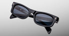 Jacques Marie Mage Initials in Lacquer dark blue rectangular sunglasses with dark lenses, front angle view.