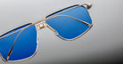 Close-up of Jacques Marie Mage Jagger sunglasses featuring oversized aviator design, blue-tinted lenses, and a sleek beta titanium metallic frame by Jacques Marie Mage, displayed on a neutral background.