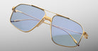 Jacques Marie Mage Jagger gold-framed oversized aviator sunglasses with blue-tinted lenses by Jacques Marie Mage, displayed on a light gray background.