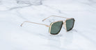 Jacques Marie Mage Jagger sunglasses, gold frame and green lenses, viewed from above.