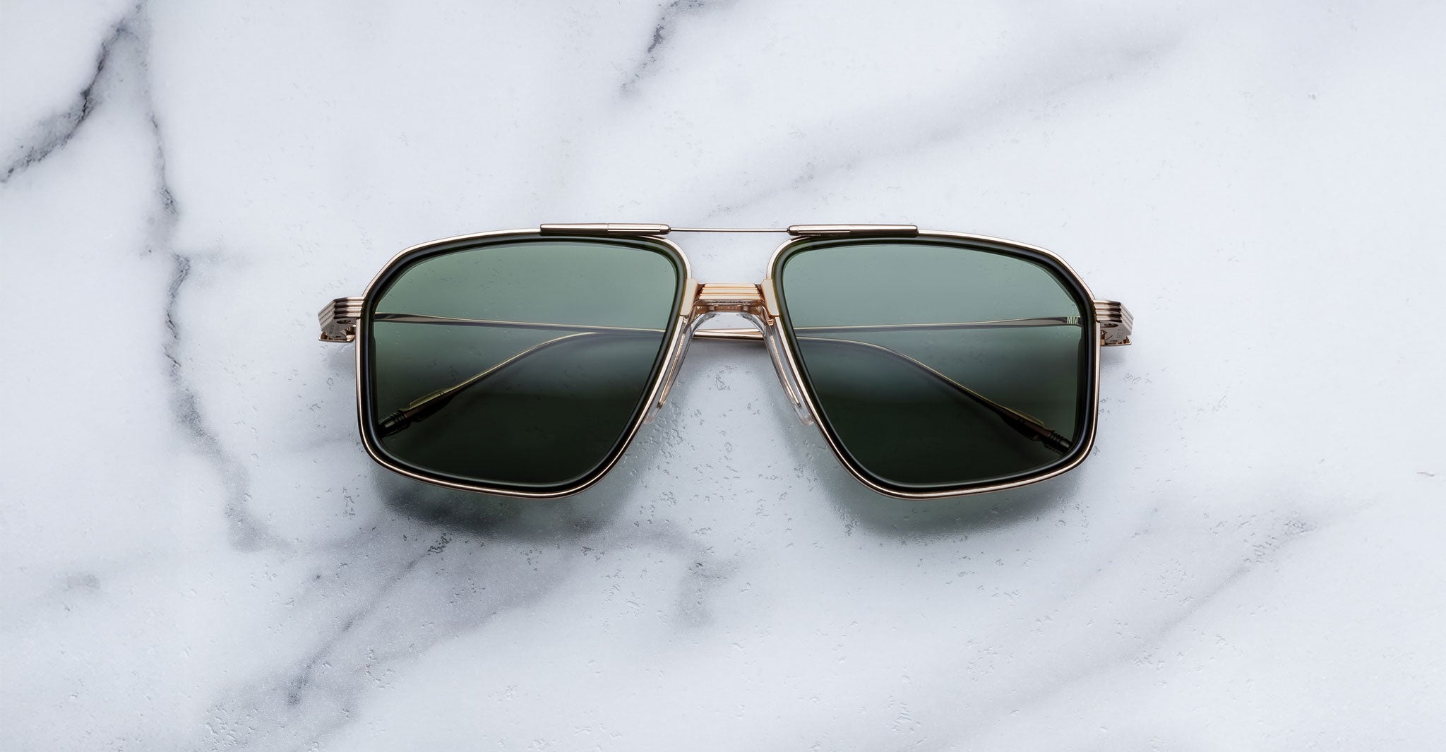 Jacques Marie Mage Jagger sunglasses, green aviator lenses with gold frames, front view.