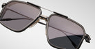Close-up of Jacques Marie Mage Jagger sunglasses by Jacques Marie Mage, showcasing oversized square aviator frames in beta titanium with dark tinted lenses against a plain light background.