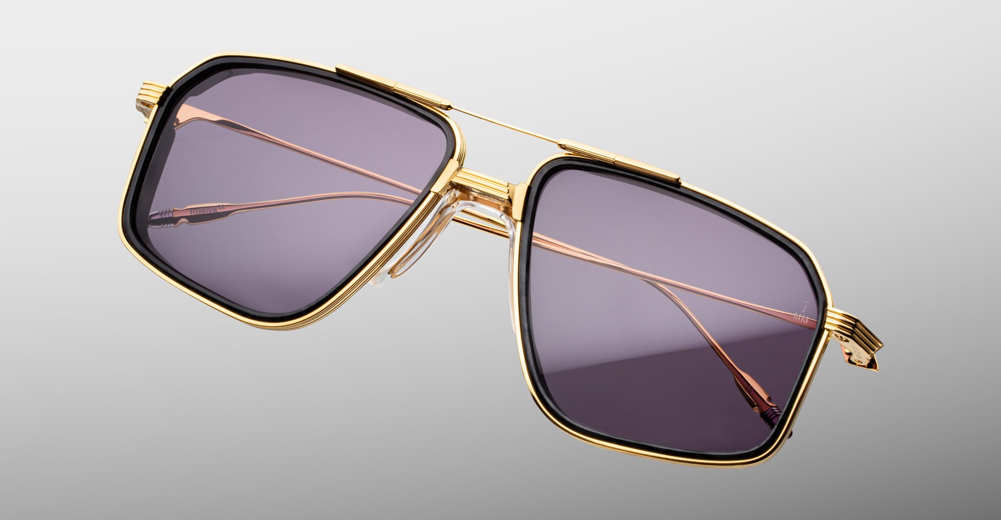 Jacques Marie Mage Jagger square sunglasses with gold rims, dark lenses, and thin metal arms shown from the front angle.