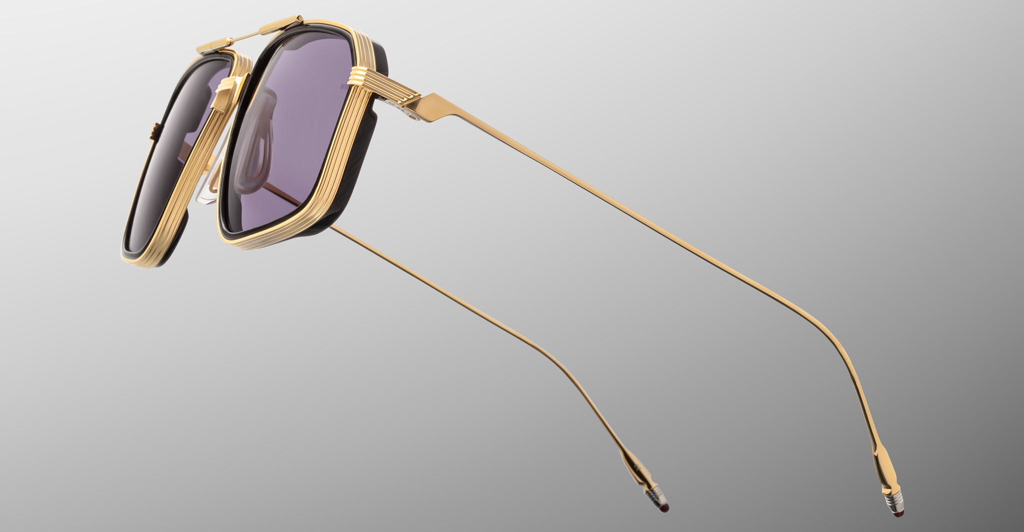 Jacques Marie Mage Jagger sunglasses, gold frames, purple lenses, angular shape, ultra-thin metal arms; front view.