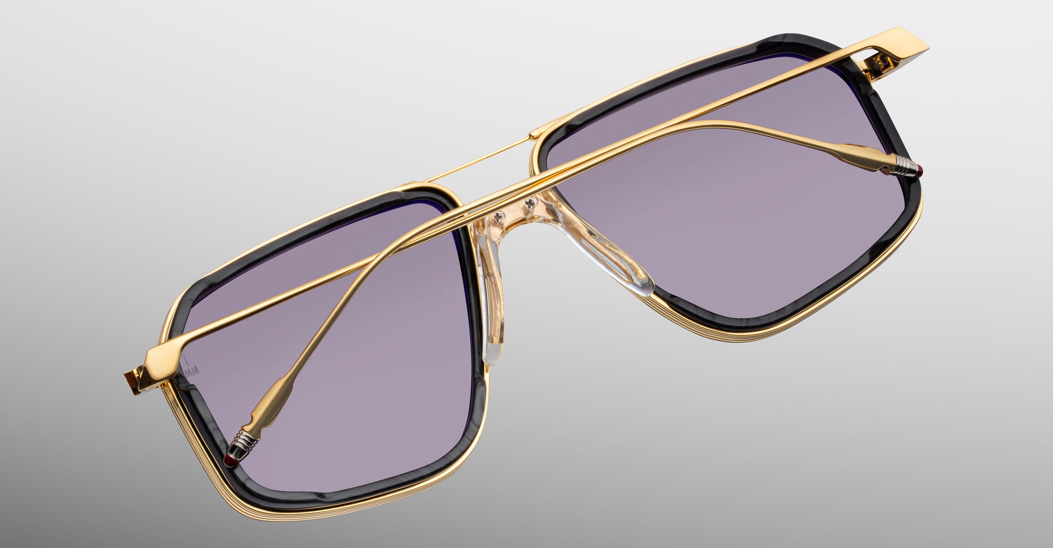 Jacques Marie Mage Jagger sunglasses with gold frames and rectangular purple lenses, shown from the front.