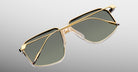 Jacques Marie Mage Jagger sunglasses by Jacques Marie Mage feature gold oversized aviator frames, dark green lenses, and clear nose pads, shown on a light gray background.