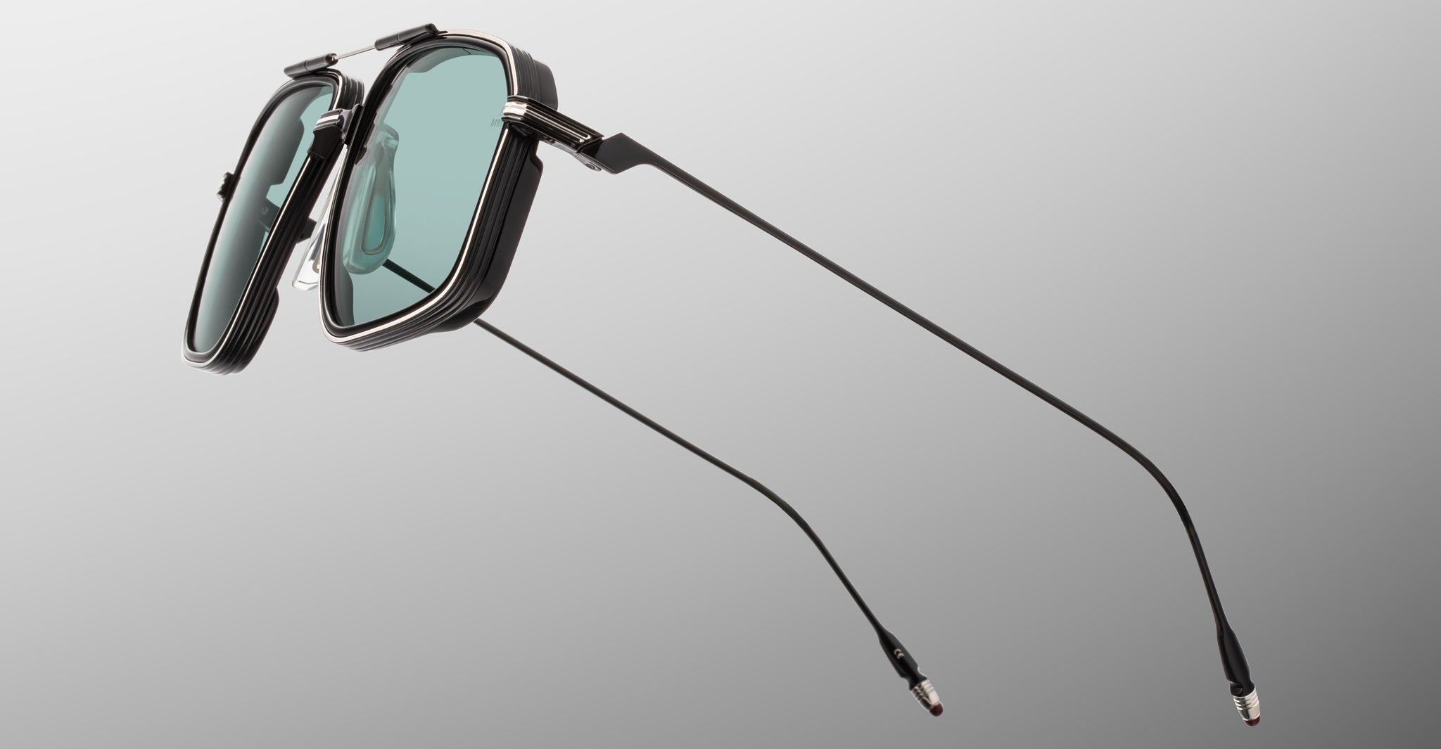 Jacques Marie Mage Jagger black sunglasses with green rectangular lenses and slim temples, front view.