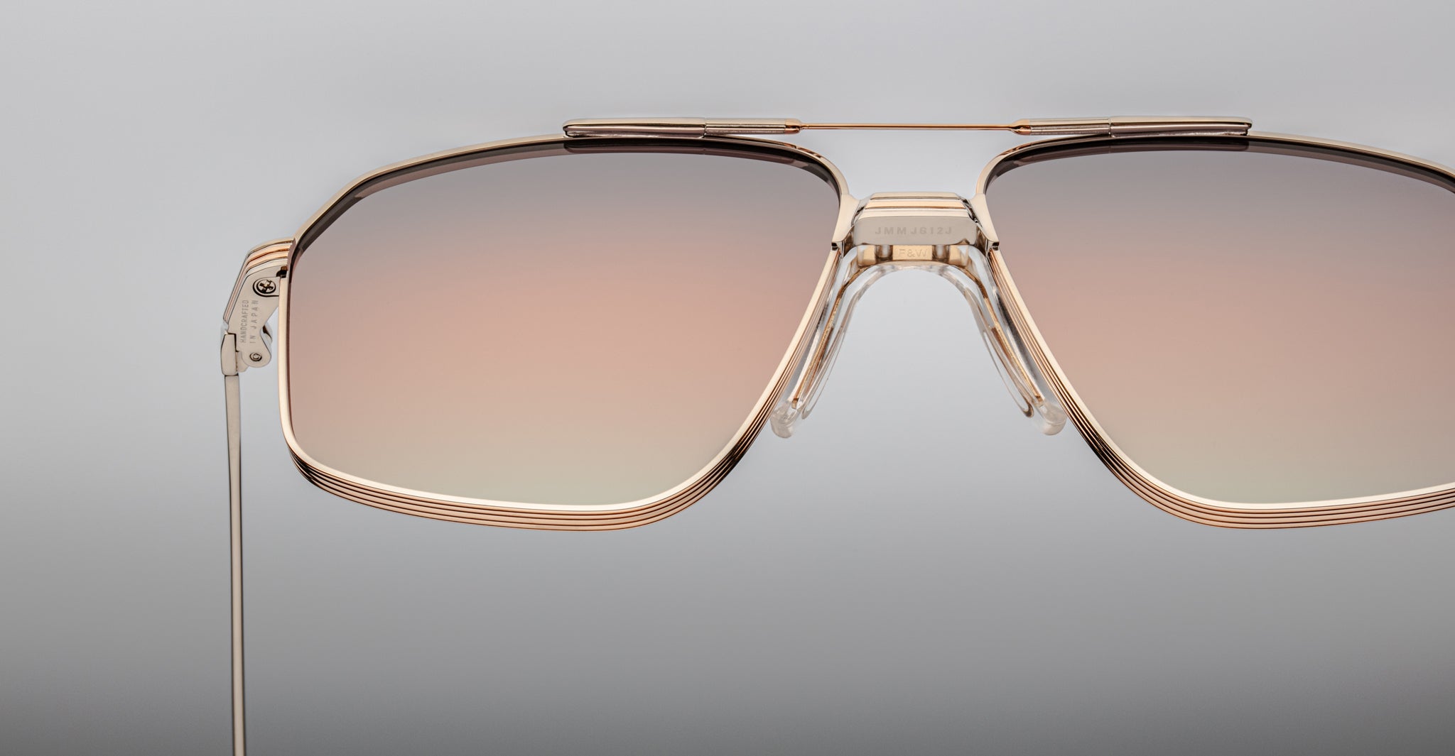 Close-up of Jacques Marie Mage Jagger aviator sunglasses featuring oversized gold frames and gradient brown-tinted lenses, set against a neutral background.