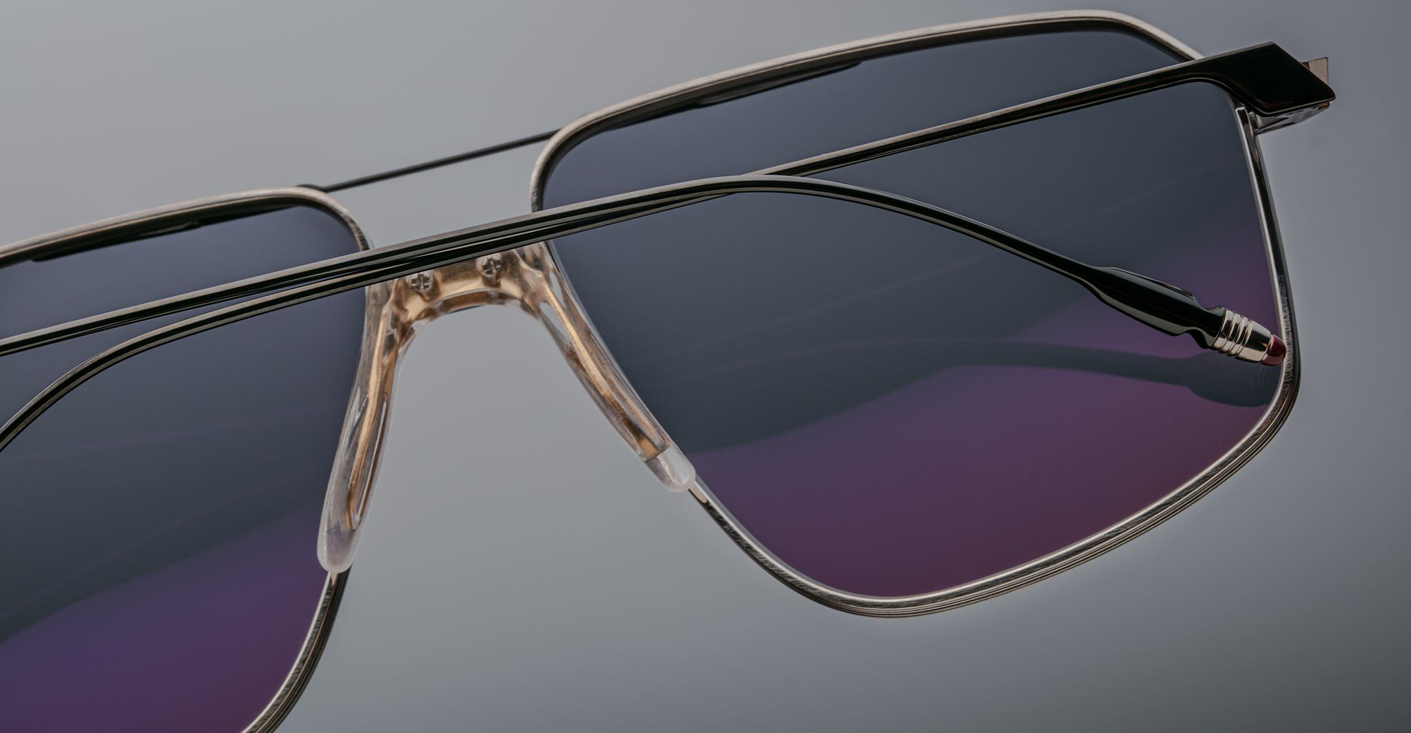 Close-up of Jacques Marie Mage Jagger oversized aviator sunglasses featuring thin beta titanium frames and dark tinted lenses, by Jacques Marie Mage, set against a plain background.