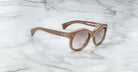 Jacques Marie Mage Jennie round beige sunglasses with UV protection shown from above.