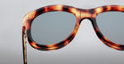 Close-up of Jacques Marie Mage Jennie sunglasses, tortoiseshell frames, blue-tinted UV lenses, viewed from the front.