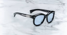 Jacques Marie Mage Jennie sunglasses with blue-tinted lenses and silver accents, top view.