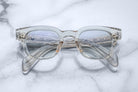 Jacques Marie Mage Julien in Beige rectangular optical frame in translucent beige acetate with a soft, neutral tone, featuring a keyhole bridge, signature arrowhead front pins, and exposed metal core detailing within the temples, shown with clear lenses.