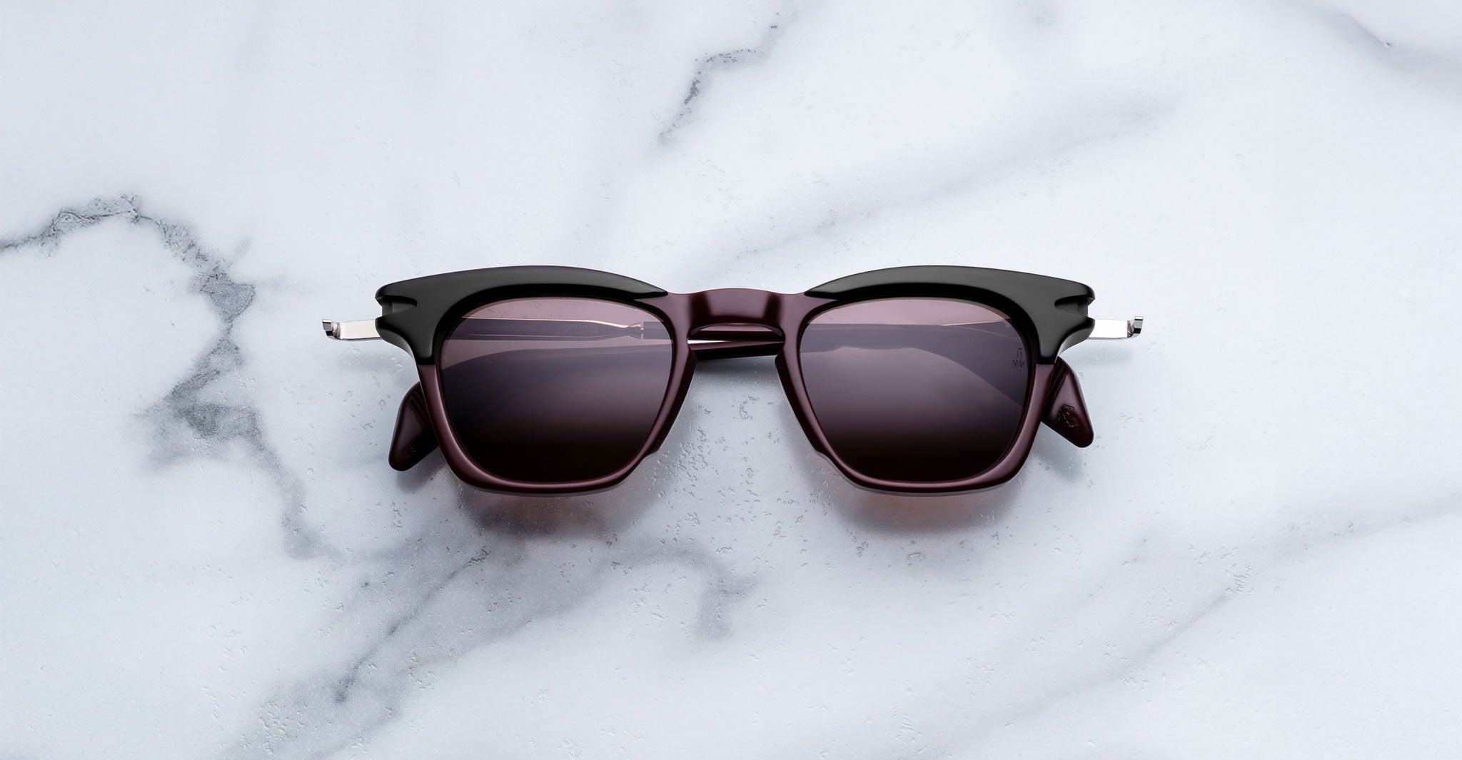 Jacques Marie Mage Kennedy sunglasses in black and dark brown with dark lenses, viewed from above.