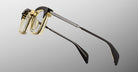 Jacques Marie Mage Kennedy eyeglasses with translucent yellow frames and black temples, front view.