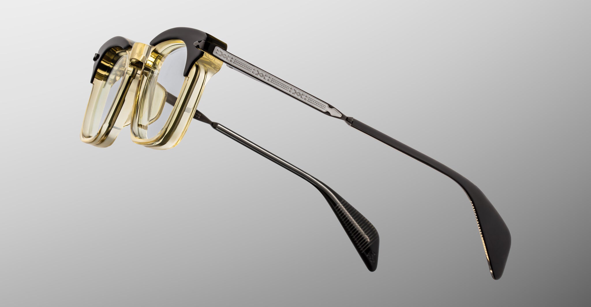 Jacques Marie Mage Kennedy eyeglasses with translucent yellow frames and black temples, front view.
