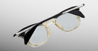 Jacques Marie Mage Kennedy eyeglasses, clear frames with black upper rims and silver temples, shown from a front-facing angle.