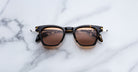 Jacques Marie Mage Kennedy sunglasses with UV-protected brown lenses, top view, showing full frame and lens details.