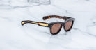 Jacques Marie Mage Kinshasa sunglasses, gold-accented arms, shown from above.