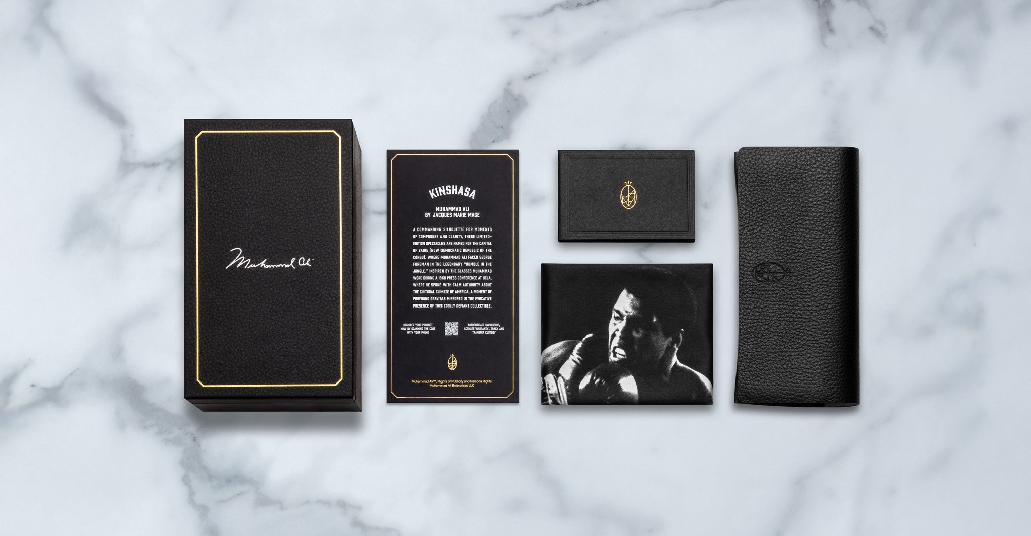 Jacques Marie Mage Kinshasa eyeglasses set with card, booklet, wallet, and boxer photo in black leather box, top view.