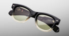 Jacques Marie Mage Kinshasa sunglasses with black and clear frames, green polarized lenses, shown from the front.