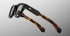 Jacques Marie Mage Kinshasa sunglasses with thick black and tortoiseshell frames, dark lenses, front view.