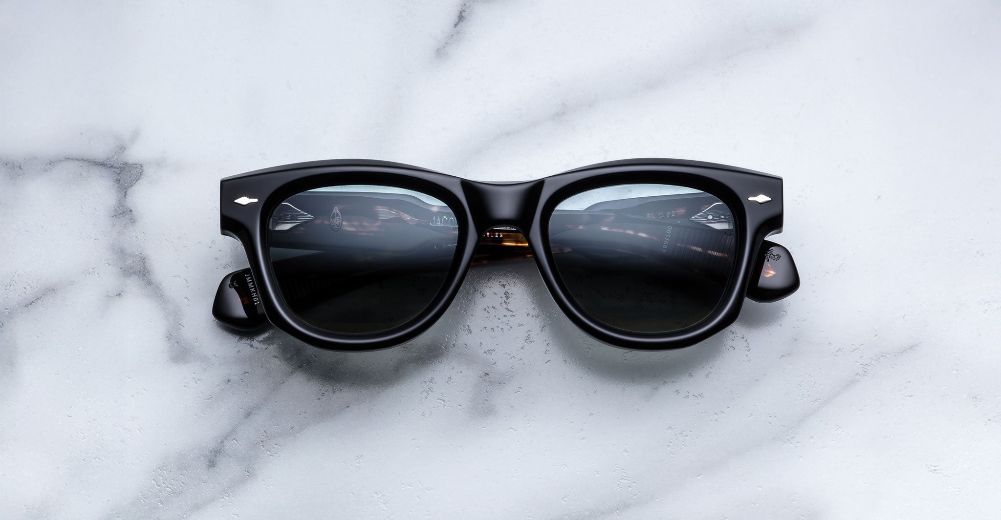 Jacques Marie Mage Kinshasa sunglasses, thick frames, front view showing lenses with soft reflections.