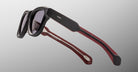 Jacques Marie Mage Kinshasa sunglasses in black and red with dark lenses, viewed at an angle.