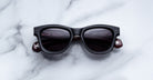 Jacques Marie Mage Kinshasa black polarized sunglasses with dark lenses, front view.