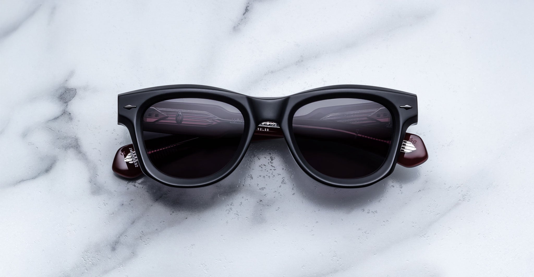 Jacques Marie Mage Kinshasa black polarized sunglasses with dark lenses, front view.