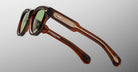 Jacques Marie Mage Kinshasa sunglasses, brown frames, green lenses, metal-accented arms, front view.