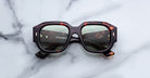 Jacques Marie Mage Lacy sunglasses with green polarized lenses, shown from above, display the brand and model clearly.