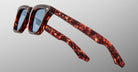 The Jacques Marie Mage Leclair sunglasses feature thick tortoiseshell-patterned frames and blue-tinted lenses, showcased at an angle against a plain light gray background.