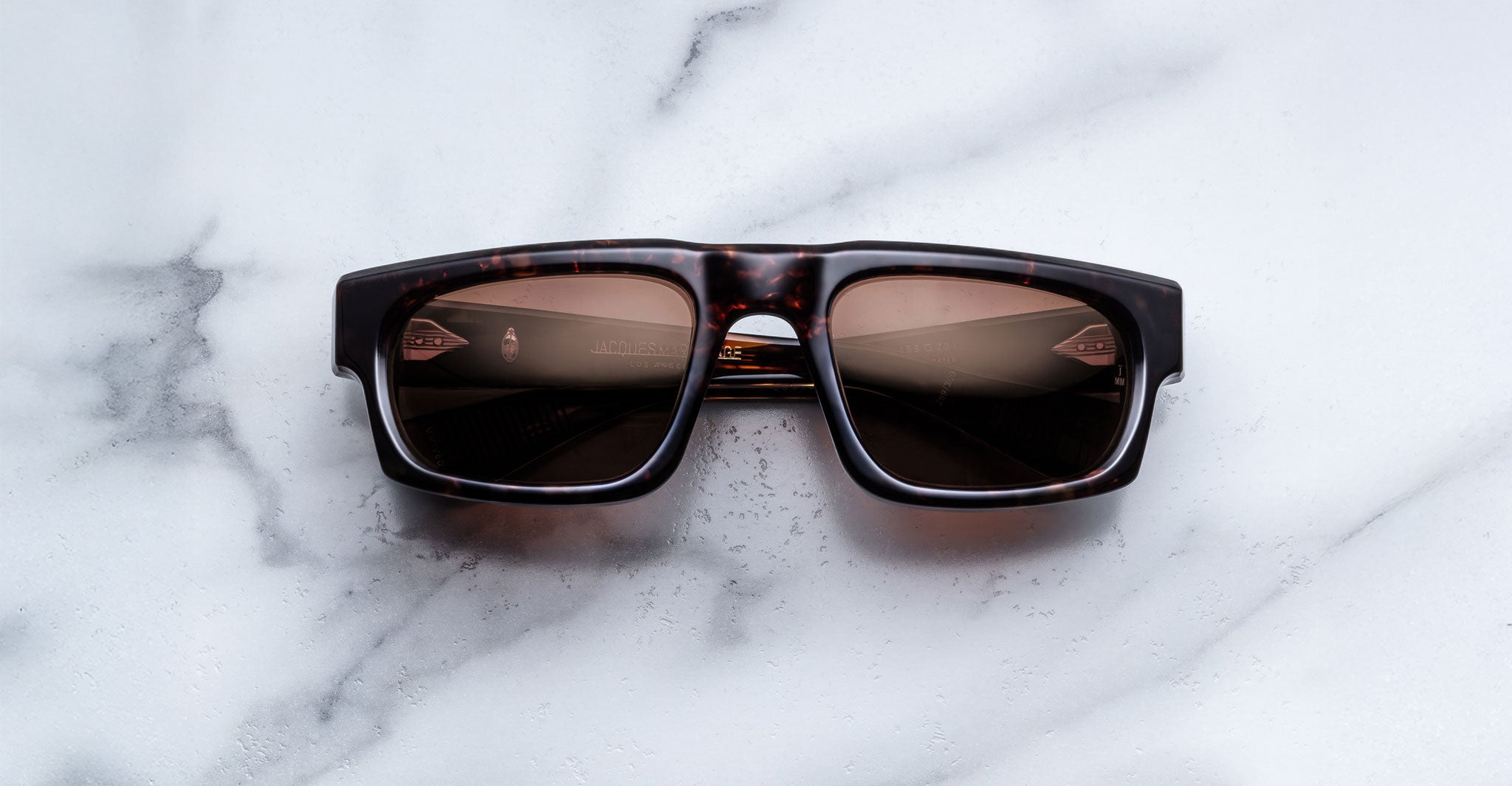 Jacques Marie Mage Louisville sunglasses with dark lenses, front view, showing thick frames and signature arrow detailing.
