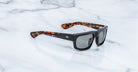 Jacques Marie Mage Louisville black polarized sunglasses with tortoiseshell arms, top view.