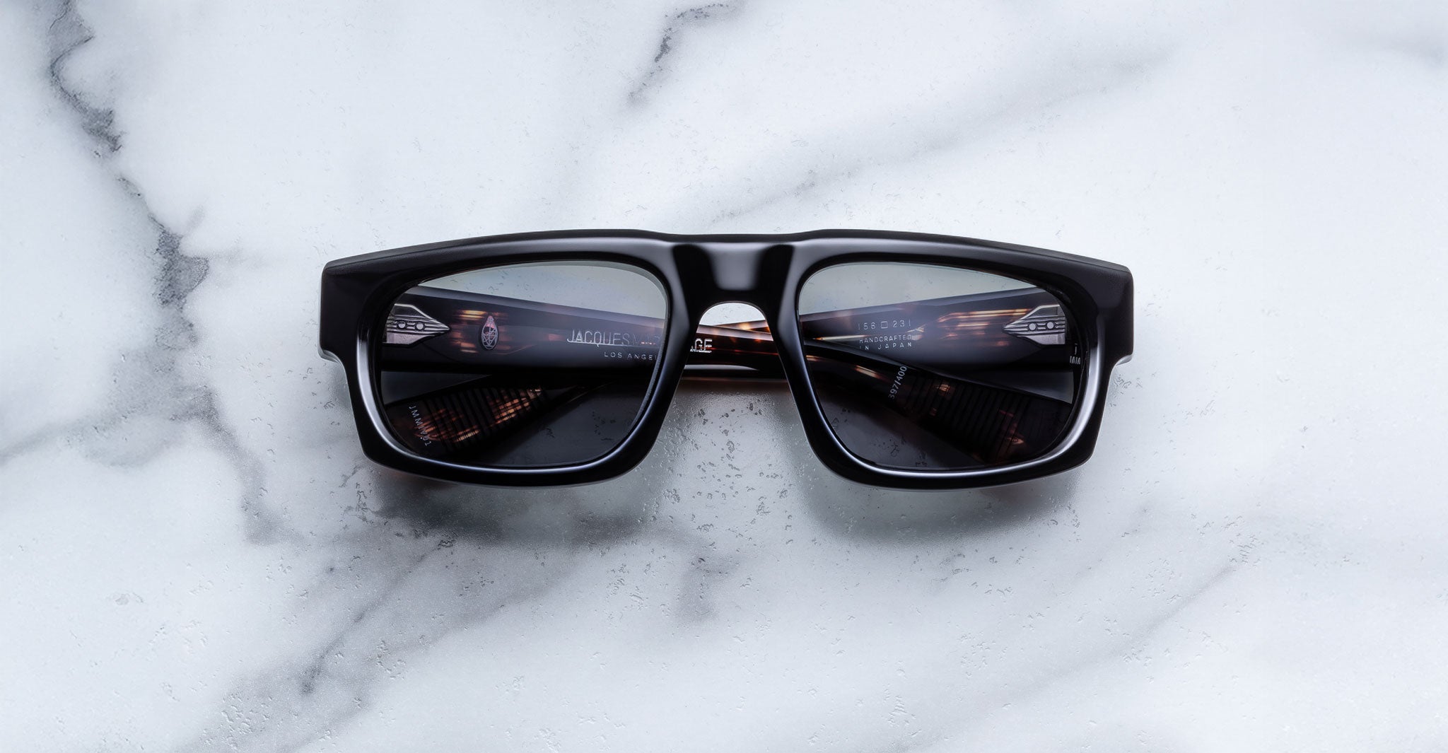 Jacques Marie Mage Louisville black rectangular sunglasses, front view, with tunnel reflection in polarized lenses.