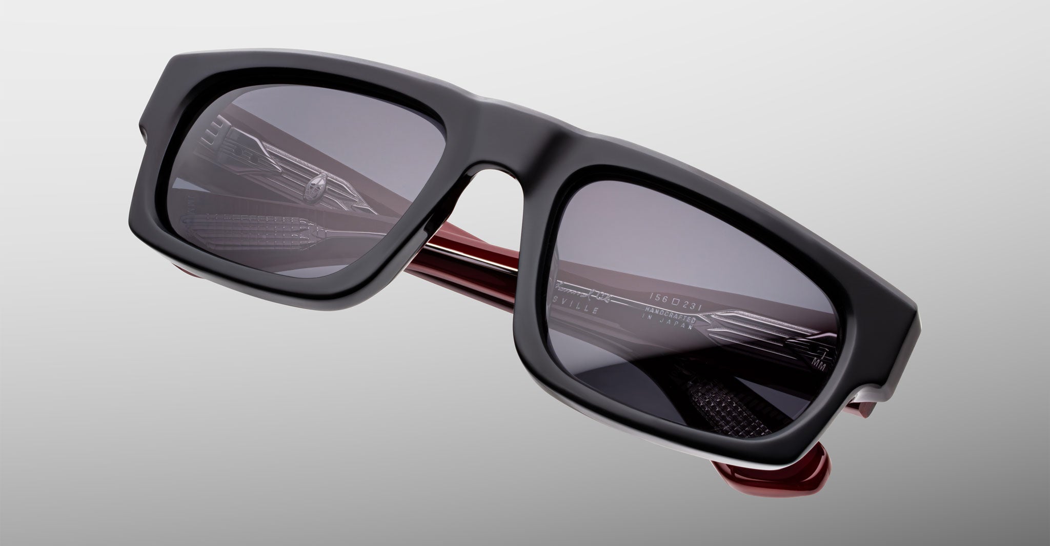 Jacques Marie Mage Louisville sunglasses, black rectangular frame, dark lenses, red inner arms, front angle view.