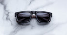 Jacques Marie Mage Louisville black rectangular sunglasses with dark polarized lenses, shown from above.
