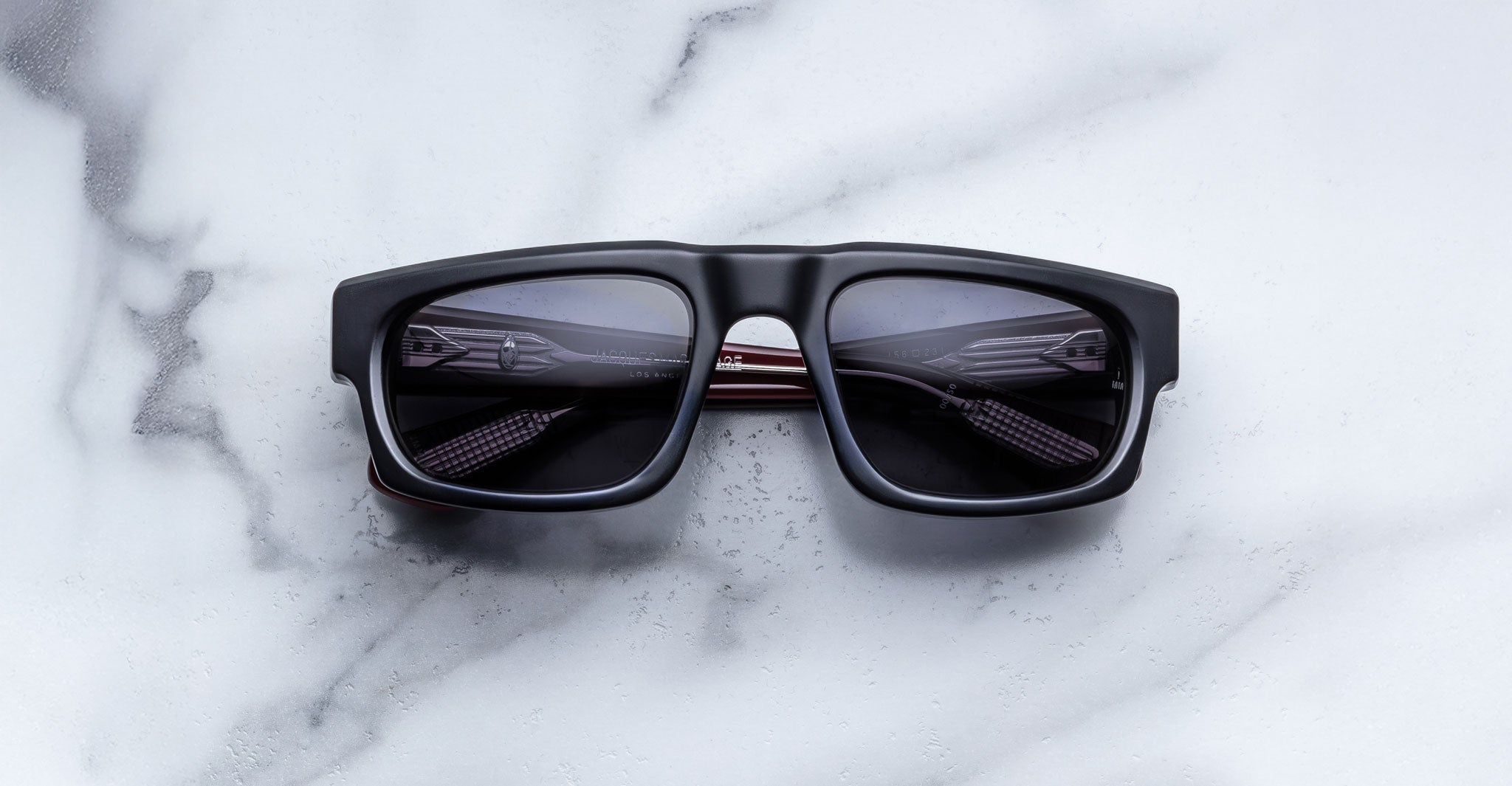 Jacques Marie Mage Louisville black rectangular sunglasses with dark polarized lenses, shown from above.
