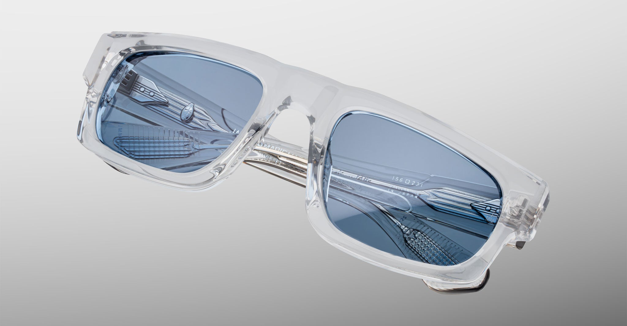 Jacques Marie Mage Louisville sunglasses with clear frames and blue rectangular lenses shown from the front.