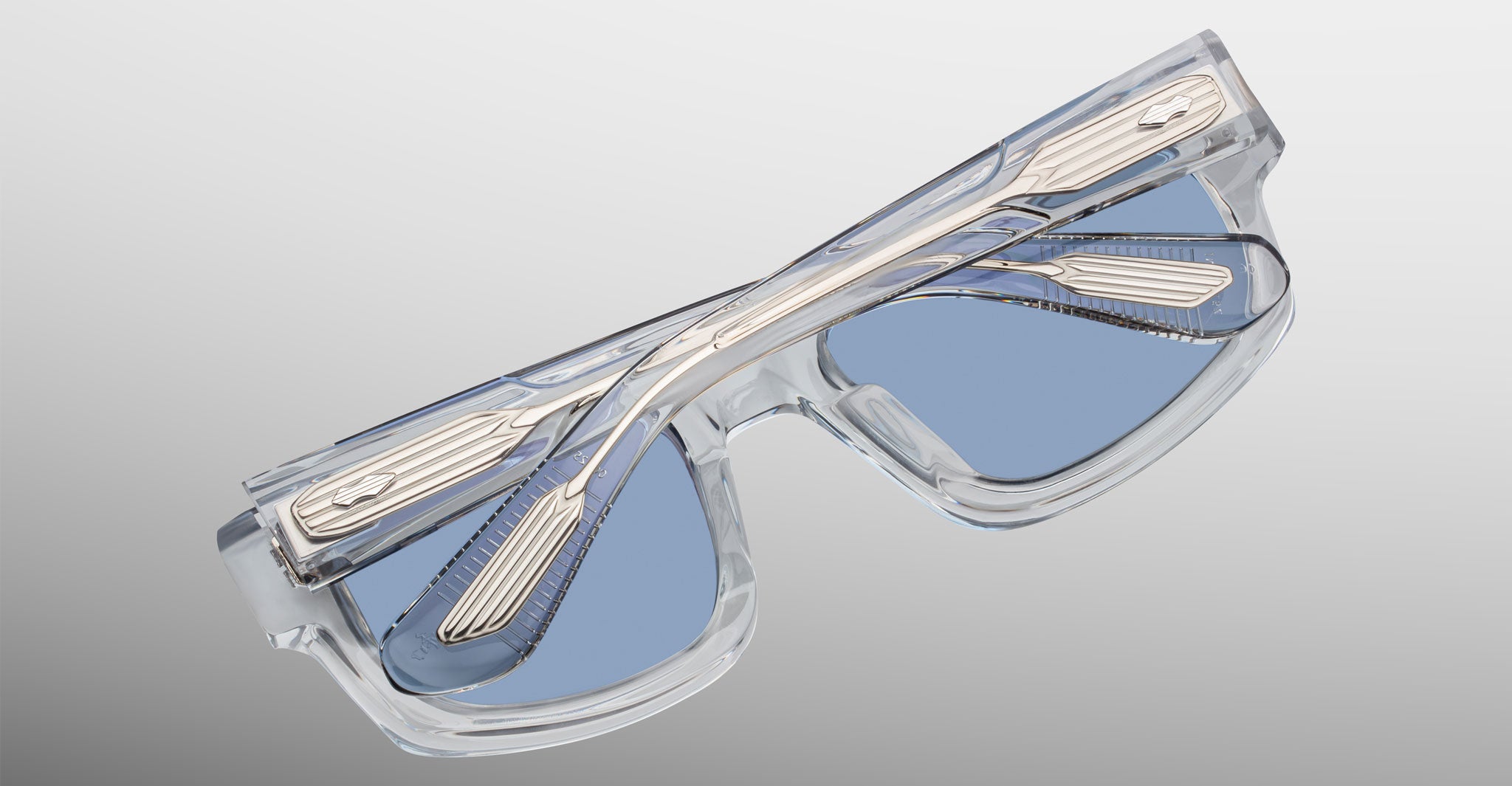 Jacques Marie Mage Louisville clear-framed blue-tinted eyeglasses folded upside down, showcasing front and top view.