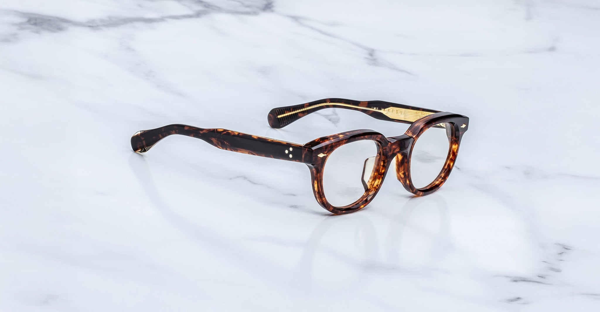 Jacques Marie Mage Matsu round tortoiseshell eyeglasses shown from above, highlighting frame shape and brand details.