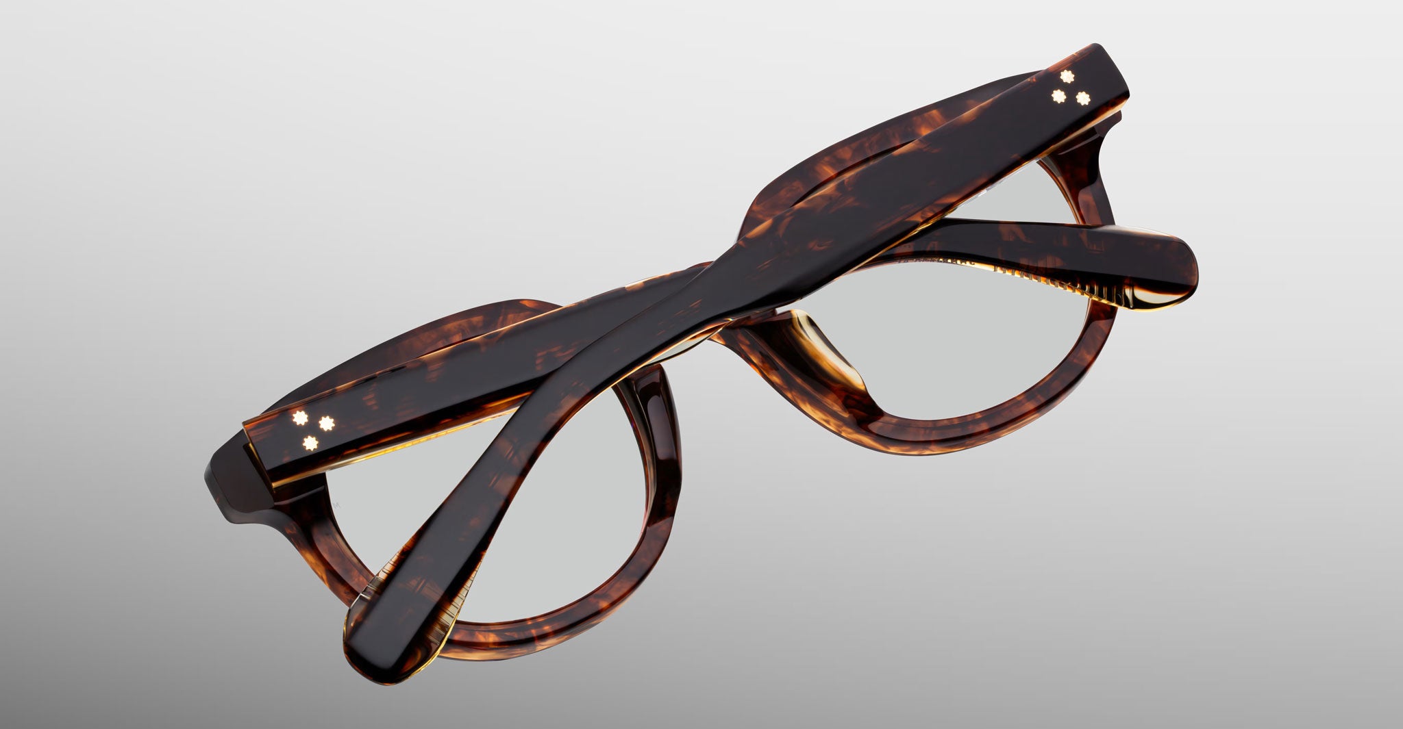 Jacques Marie Mage Matsu tortoiseshell eyeglasses with arms folded, top view displaying frame and temple design.